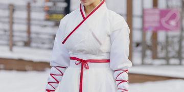 눈 내린 야외 배경에서 흰색 바탕에 붉은색 선이 들어간 사극 의상을 입고 머리를 하나로 높게 묶은 채 목검을 들고 진지하게 훈련 중인 배우 차주영의 모습