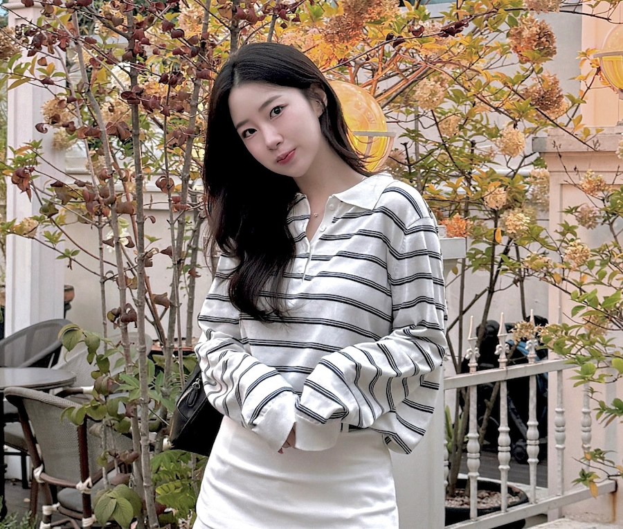 카페 테라스에서 스트라이프 상의를 입고 일상 분위기를 연출한 이윤선