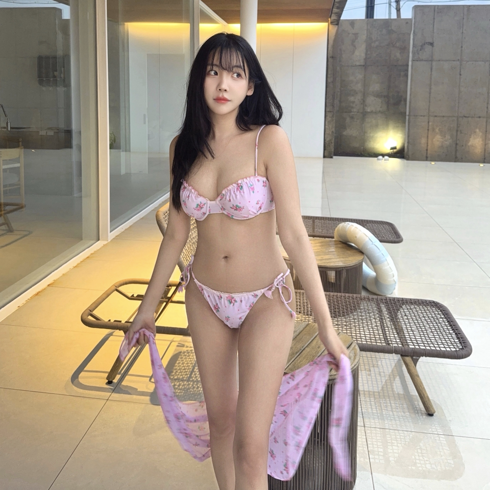 분홍색 꽃무늬 비키니를 입고 수영장 근처에 선 레이나